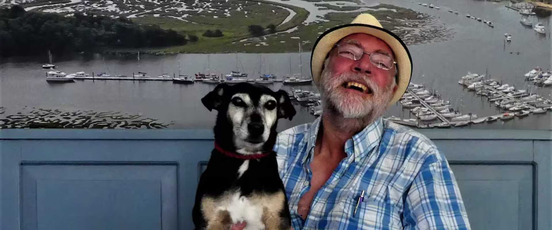A man holding a Jack Russell dog