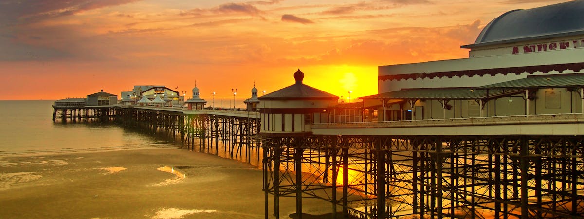 Sun setting over the historic North Pier in Blackpool, UK