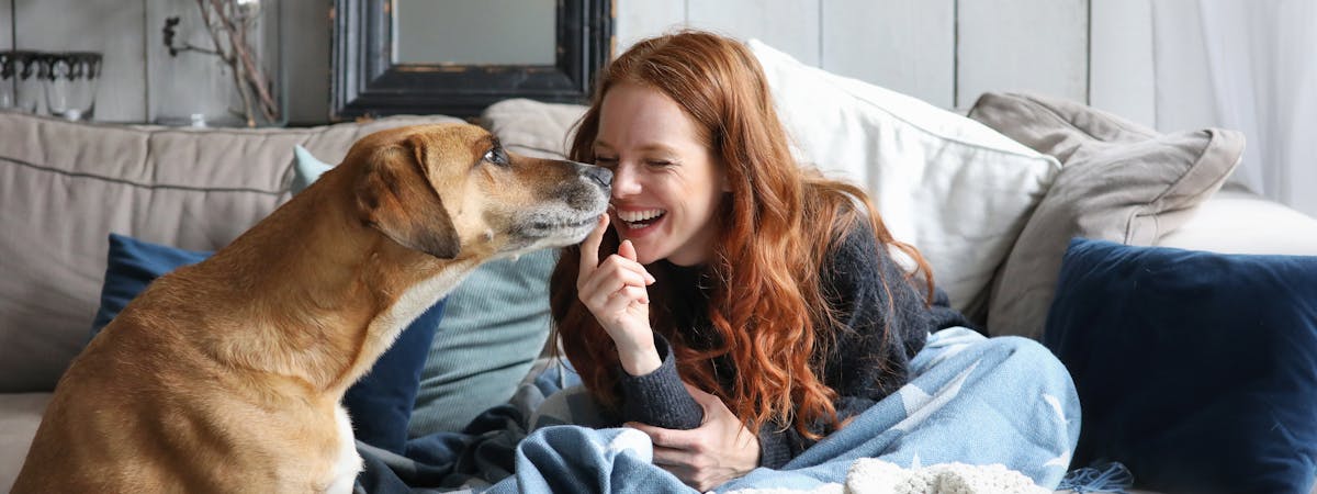 A woman playing with a dog