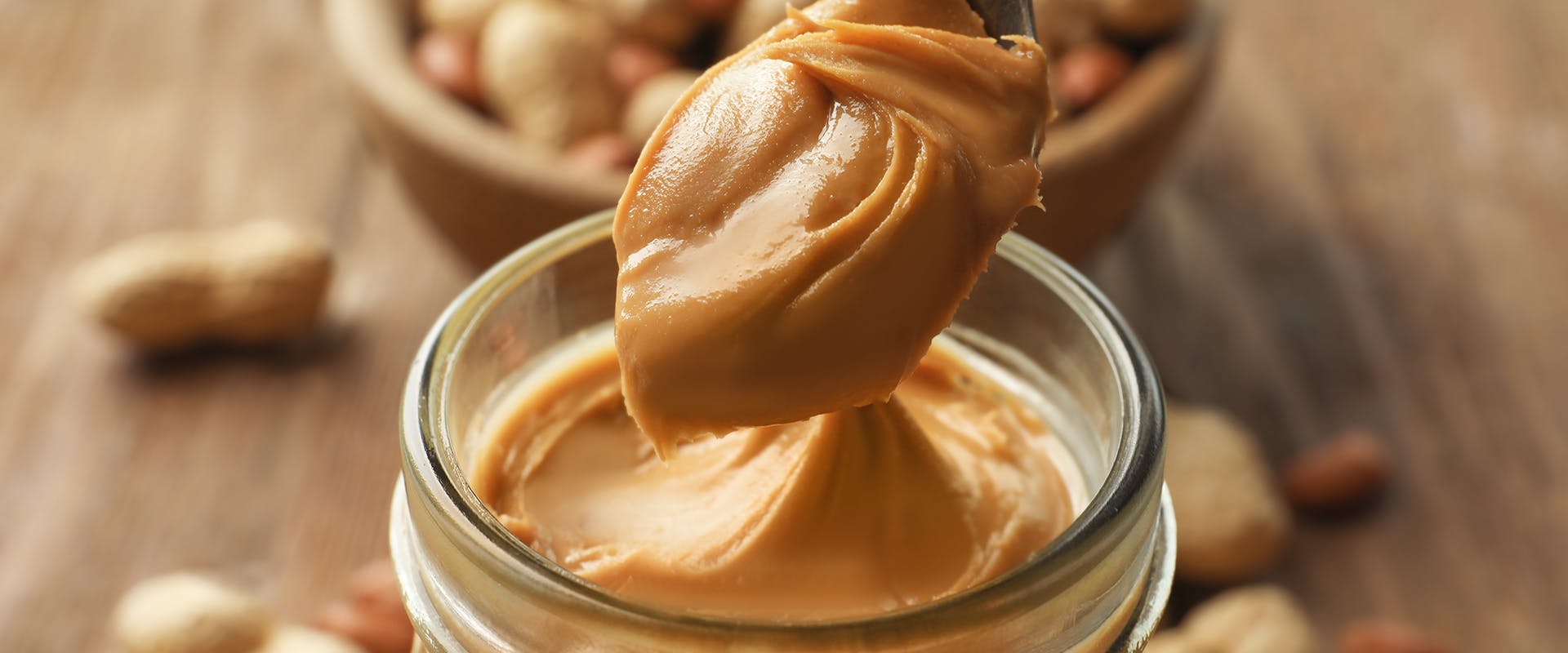 A spoonful of peanut butter from a jar