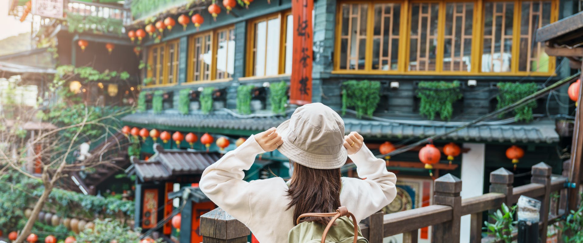 solo female traveler looking out over an old Chinese town