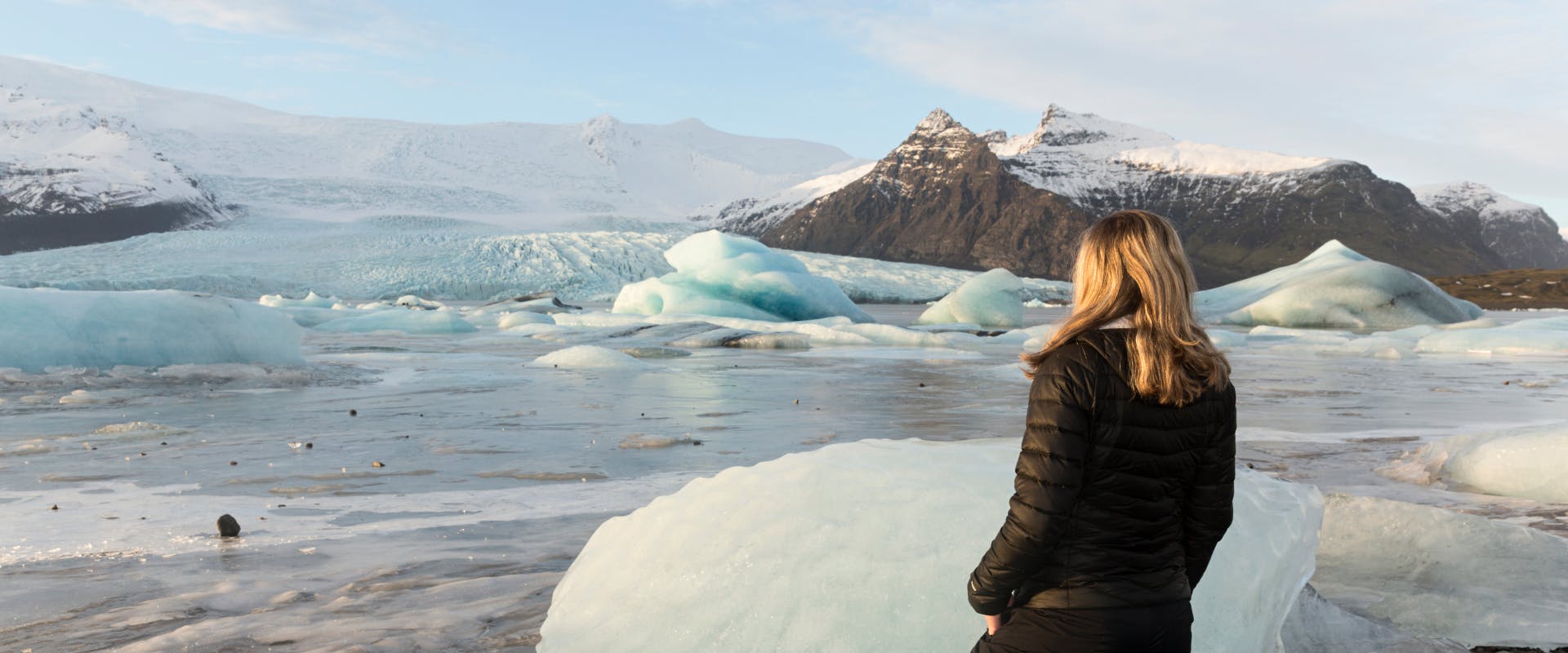 solo female traveler looking at a glacier in the center of iceland