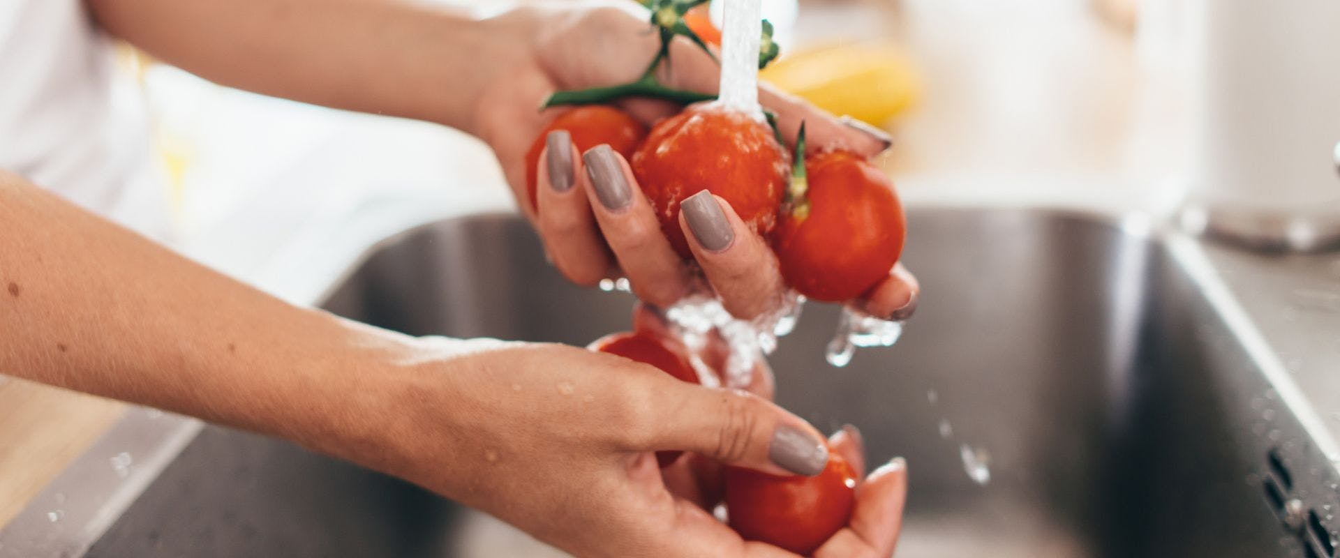 Person washing tomatoes