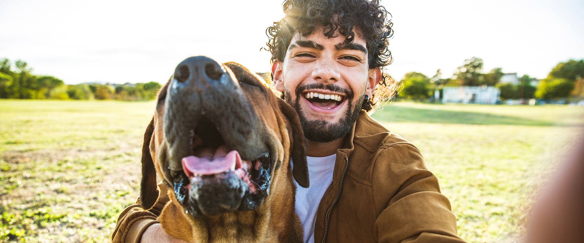 A man taking a selfie with his dog