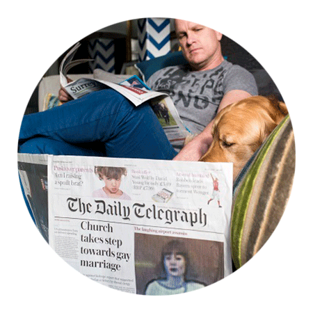 Guest blog author Daryl Cygler reading a newspaper with a dog
