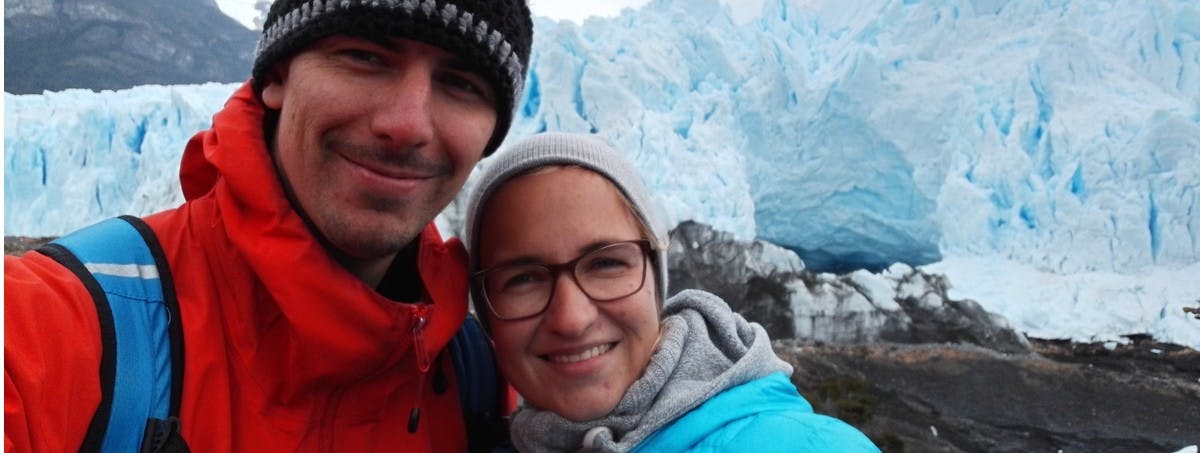 Couple standing infront of Iceberg on house sit