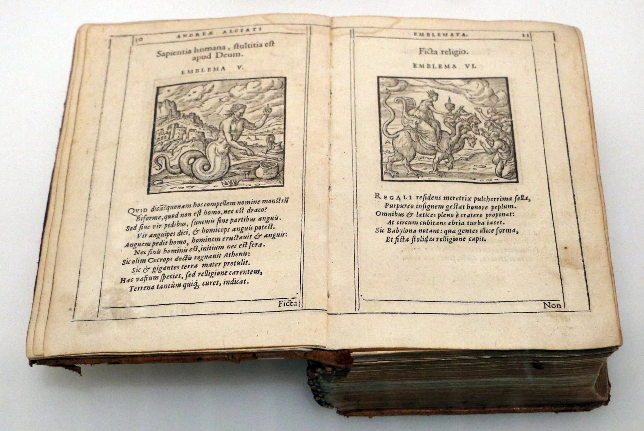 A worn early modern printed volume, reportedly a 1608 Leiden edition of Andrea Alciato's Emblemata.