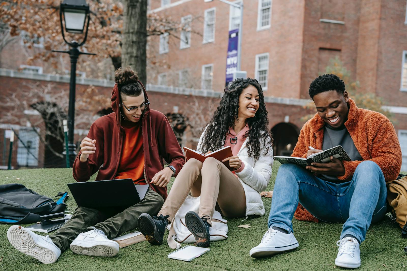 College students sitting on astroturf.