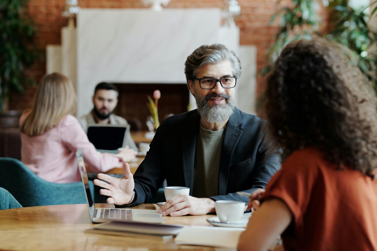 Image of a man and a lady chatting over a cup of coffee in a café