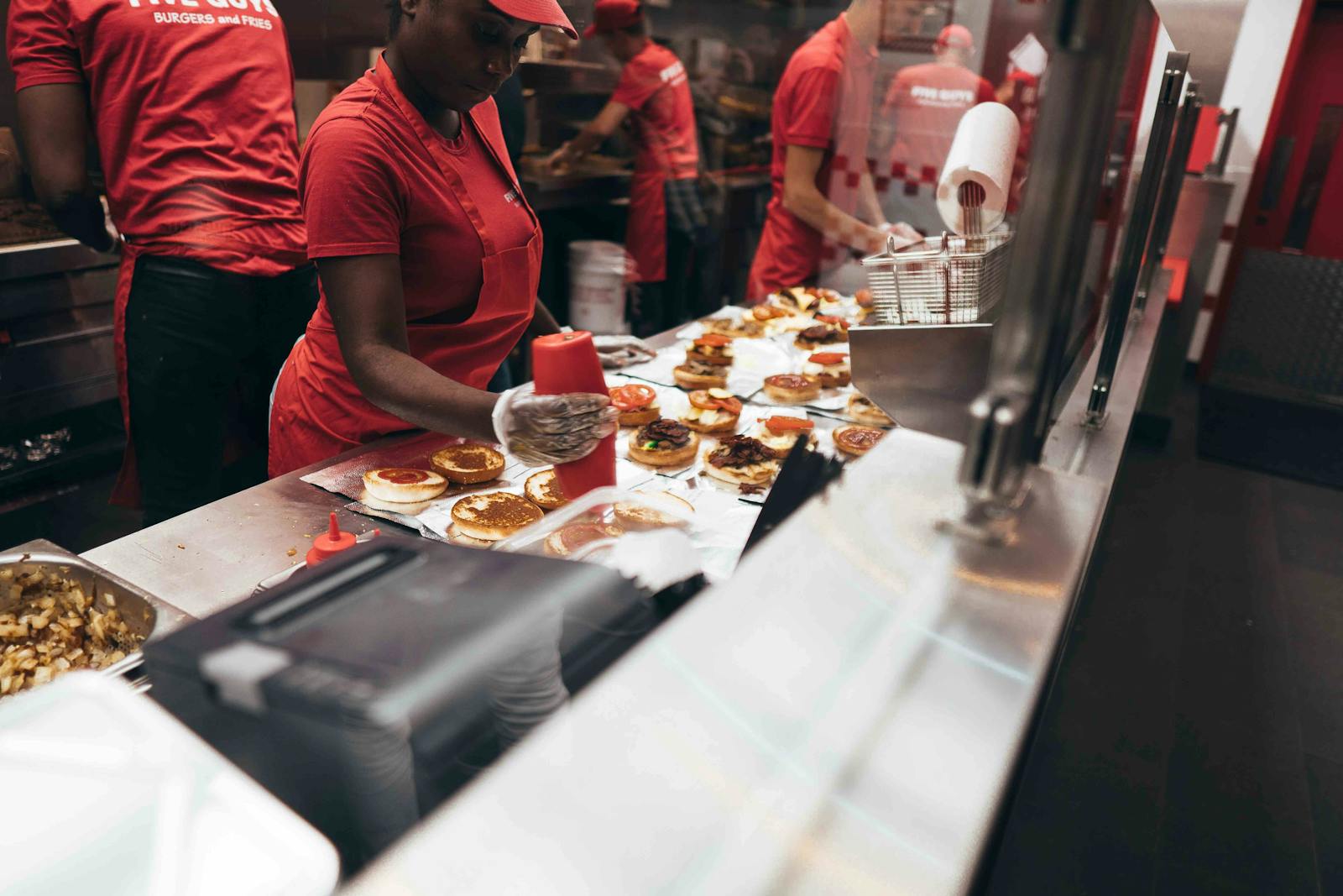 Image of workers preparing food in a chain restaurant
