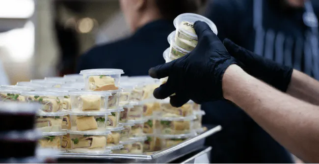 Image of a restaurant order packing wraps into containers