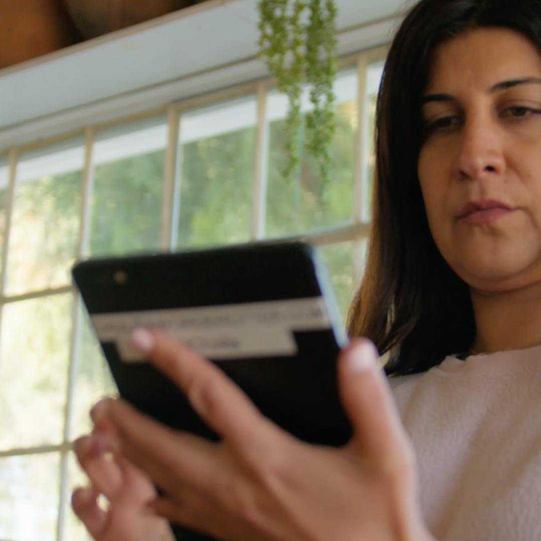 Image of a woman restaurant owner managing orders on her tablet