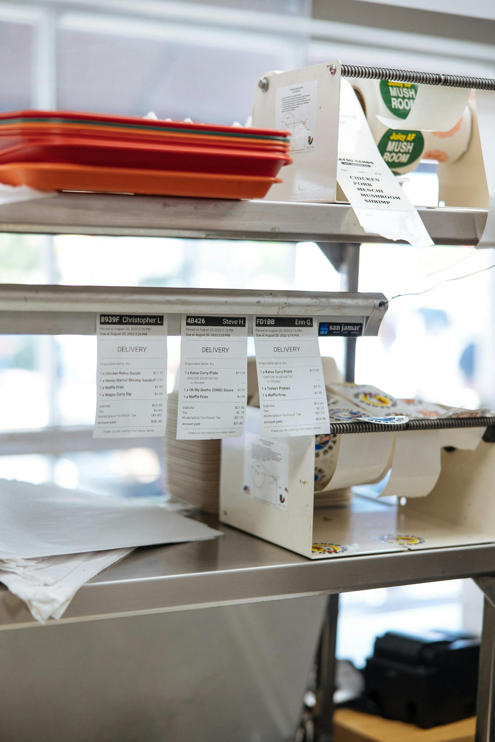 Image of restaurant order tickets hanging that were printed from the POS system