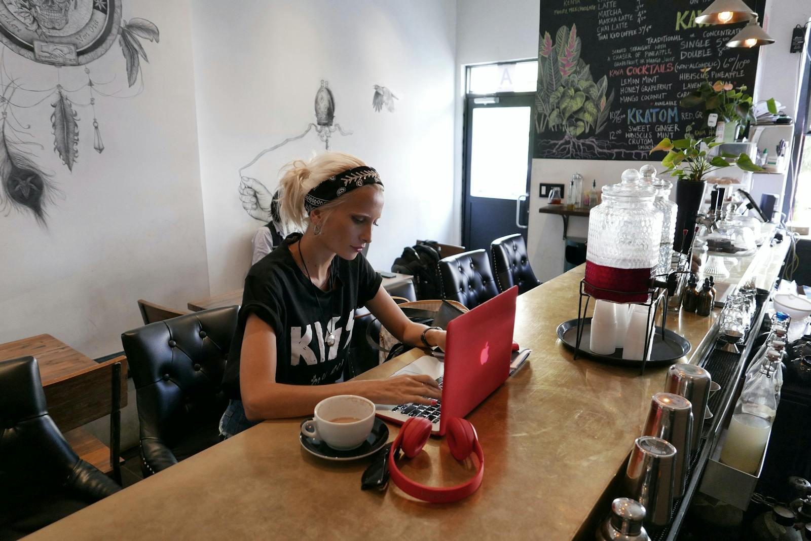 Restaurant owner sitting at counter on computer. 