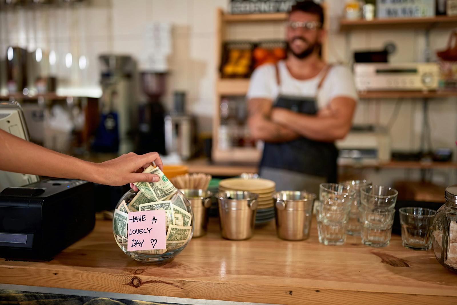 Image of a tip jar on the cashier's station in a restaurant