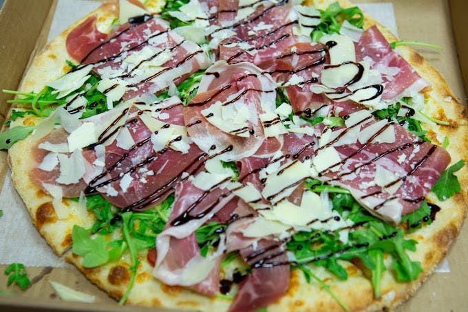 A prosciutto-arugula pizza from Amore Pizzeria. 