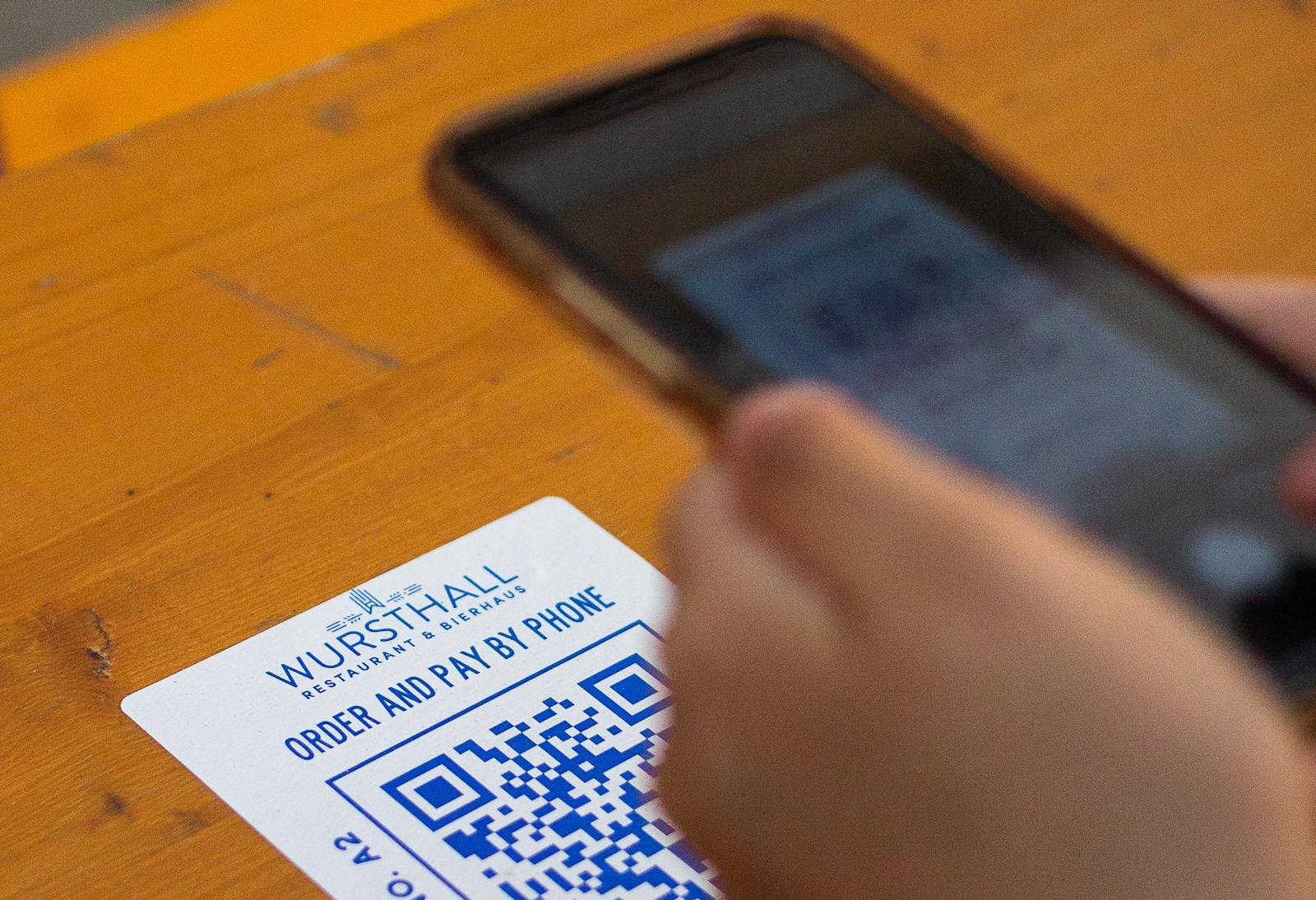 Cell phone scanning a restaurant's QR code menu.