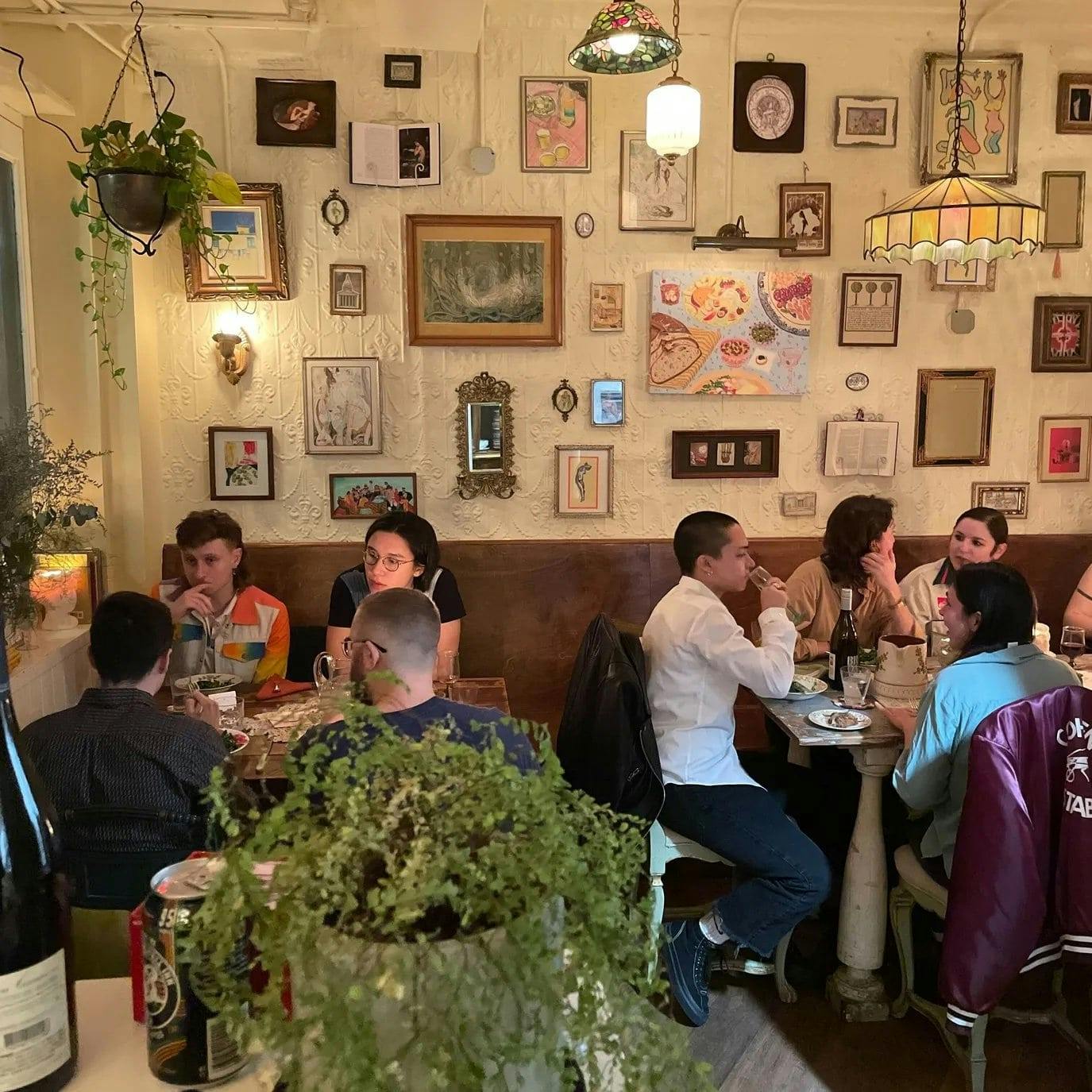 People eating inside Dinner Party in NYC.