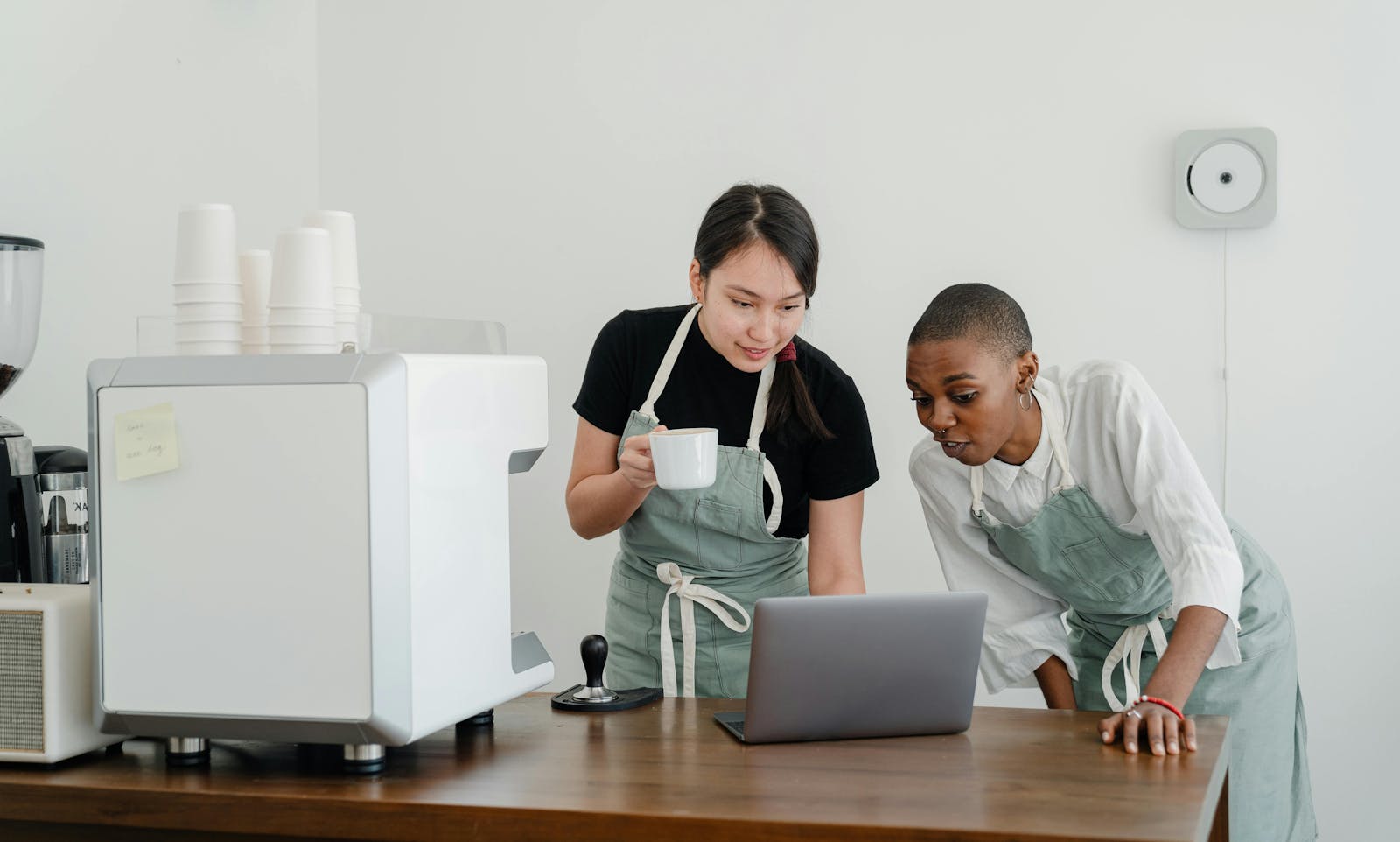 Two restaurant staff members crating email templates.