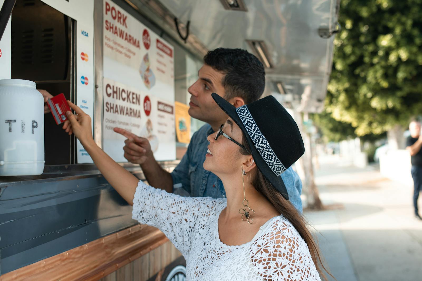 Couple ordering from a shawarma food truck. 