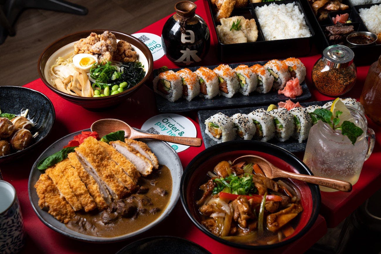 Image of a spread of Japanese food including katsu curry rice, sushi and ramen.