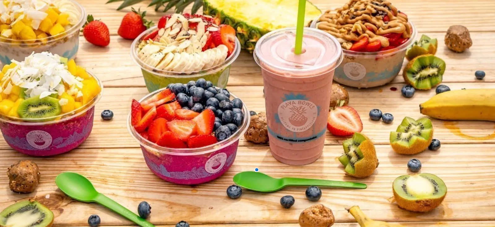 Image of assorted Playa Bowls items including smoothies and acai bowls on a table