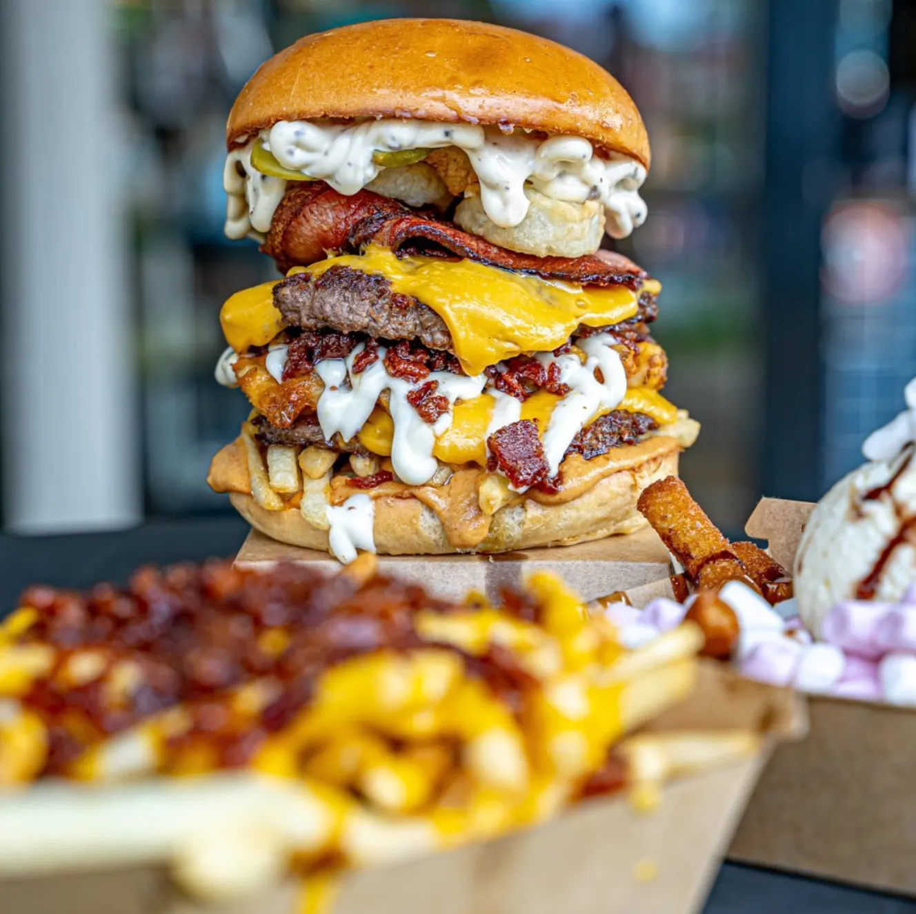 Image of a triple patty burger with melting cheese
