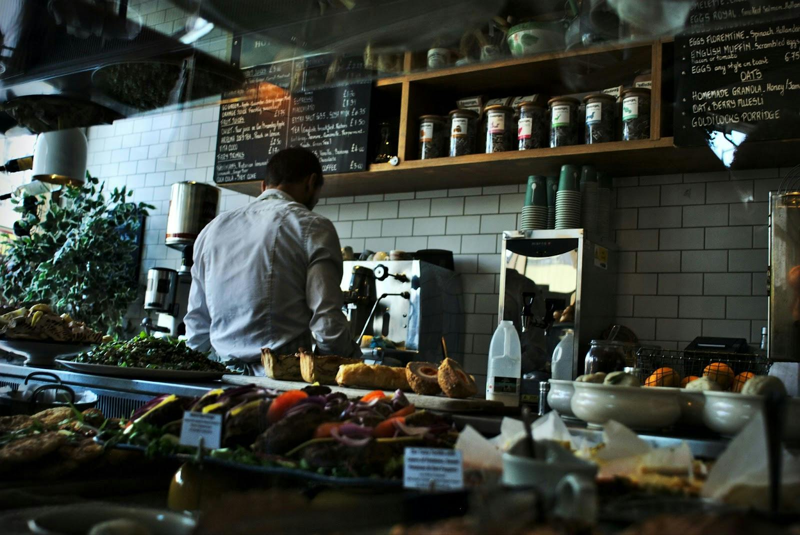 Image of a restaurant staff making coffee in an open kitchen