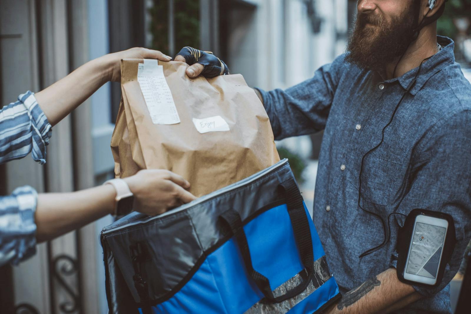 Image of a modern day delivery courier dropping off food to a customer