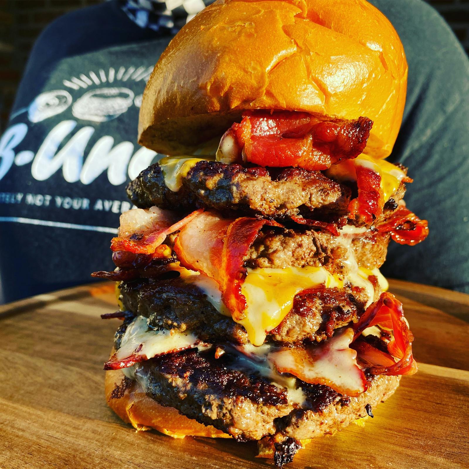 Image of B-Unos famous burger loaded with tons of patties, bacon and cheese