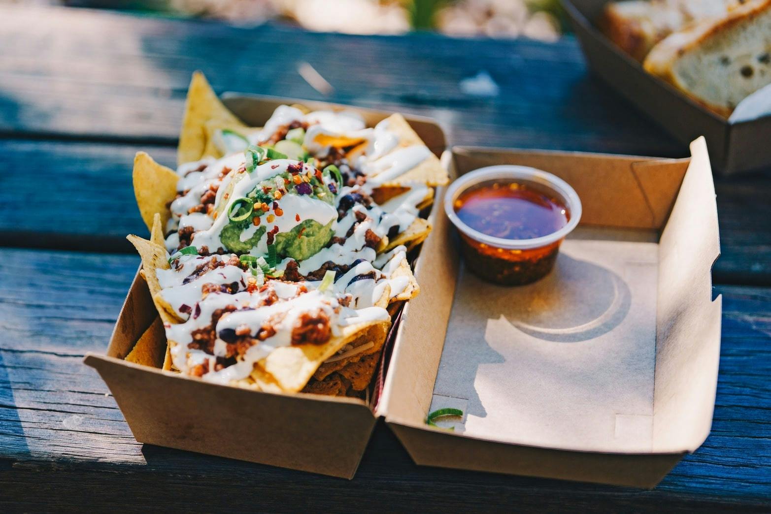 Image of to-go nachos in compostable packaging
