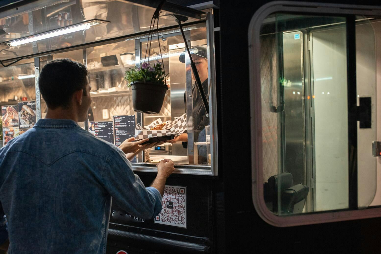 Image of a customer collecting food from a food truck
