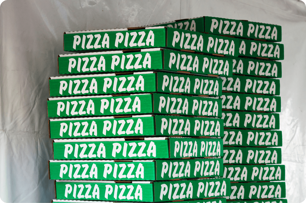 Image of stacked green pizza boxes 