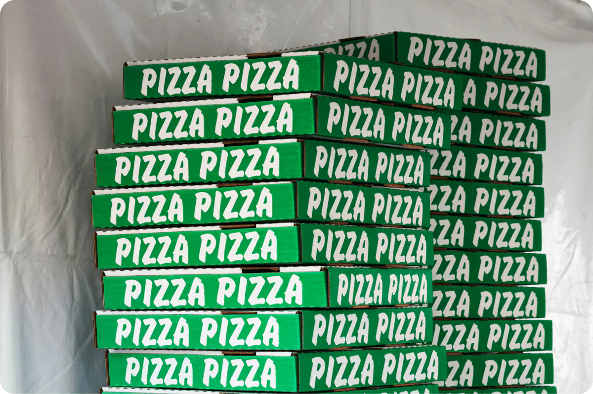 Image of stacked green pizza boxes