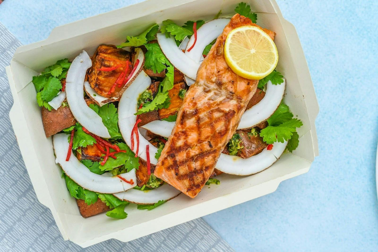 Image of a salmon salad in a takeaway box