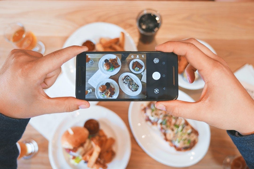 Image of a phone camera over a table filled with food