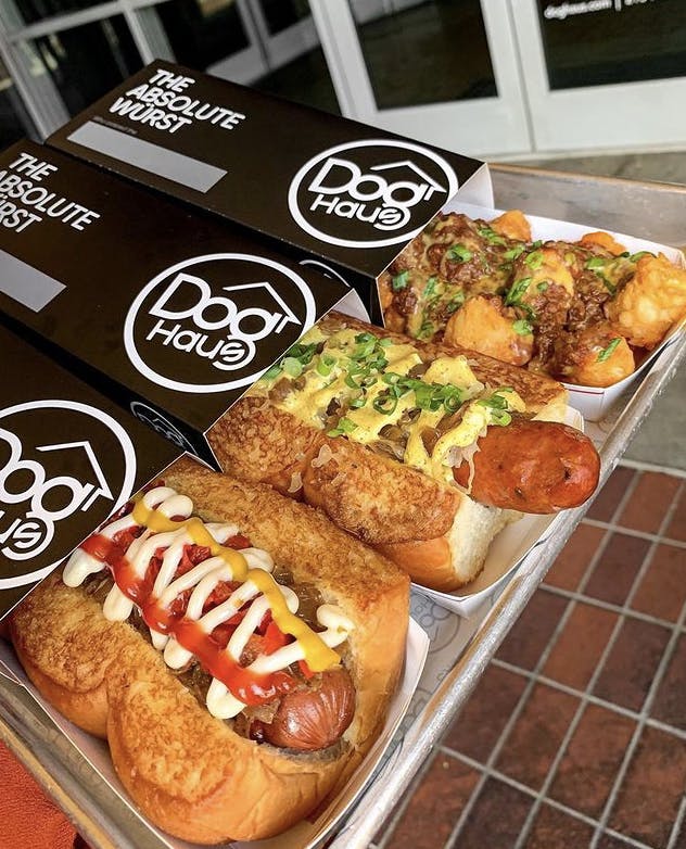 Image of two Dog Haus hot dogs and one order of loaded Dog Haus tater tots