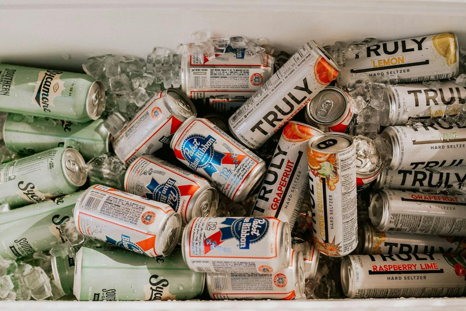 Image of a cooler box filled with canned drinks and ice