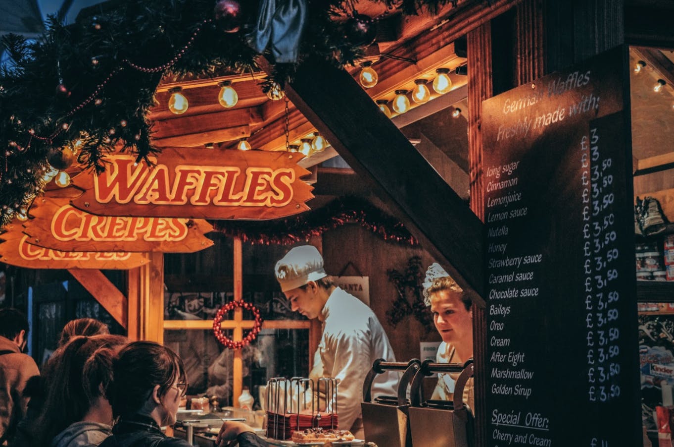 Image of a food stand selling waffles and crepes at a Christmas market