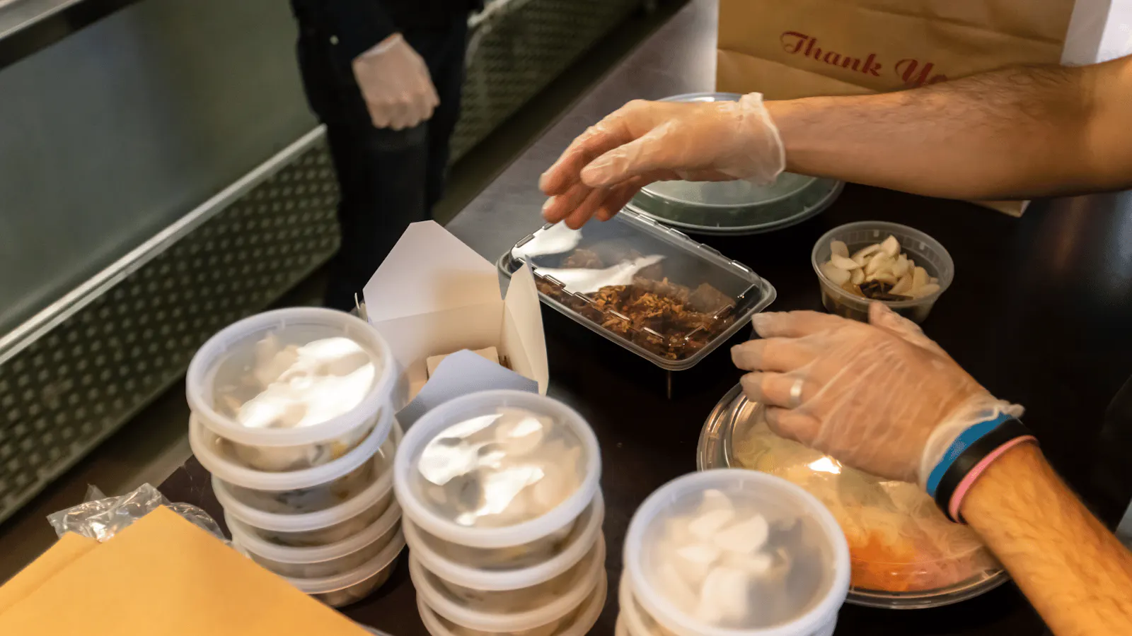 Image of a restaurant employee packing delivery orders