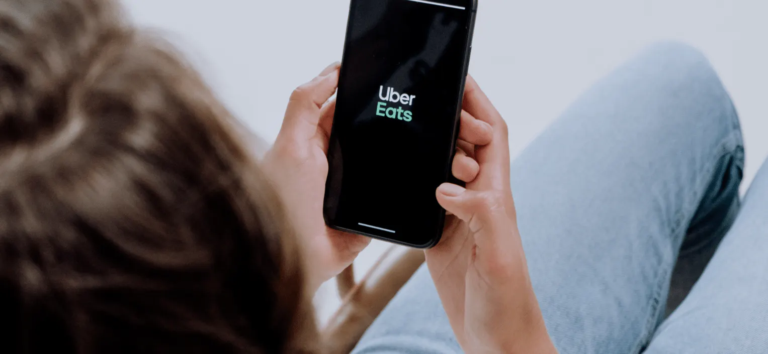 Image of a person using the Uber Eats app on their phone