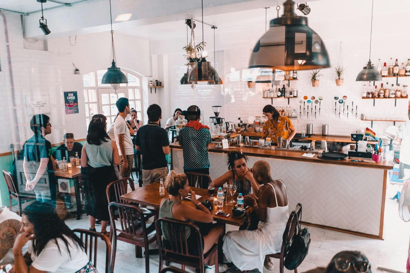 Image of a busy cafe with customers queuing to order at the counter