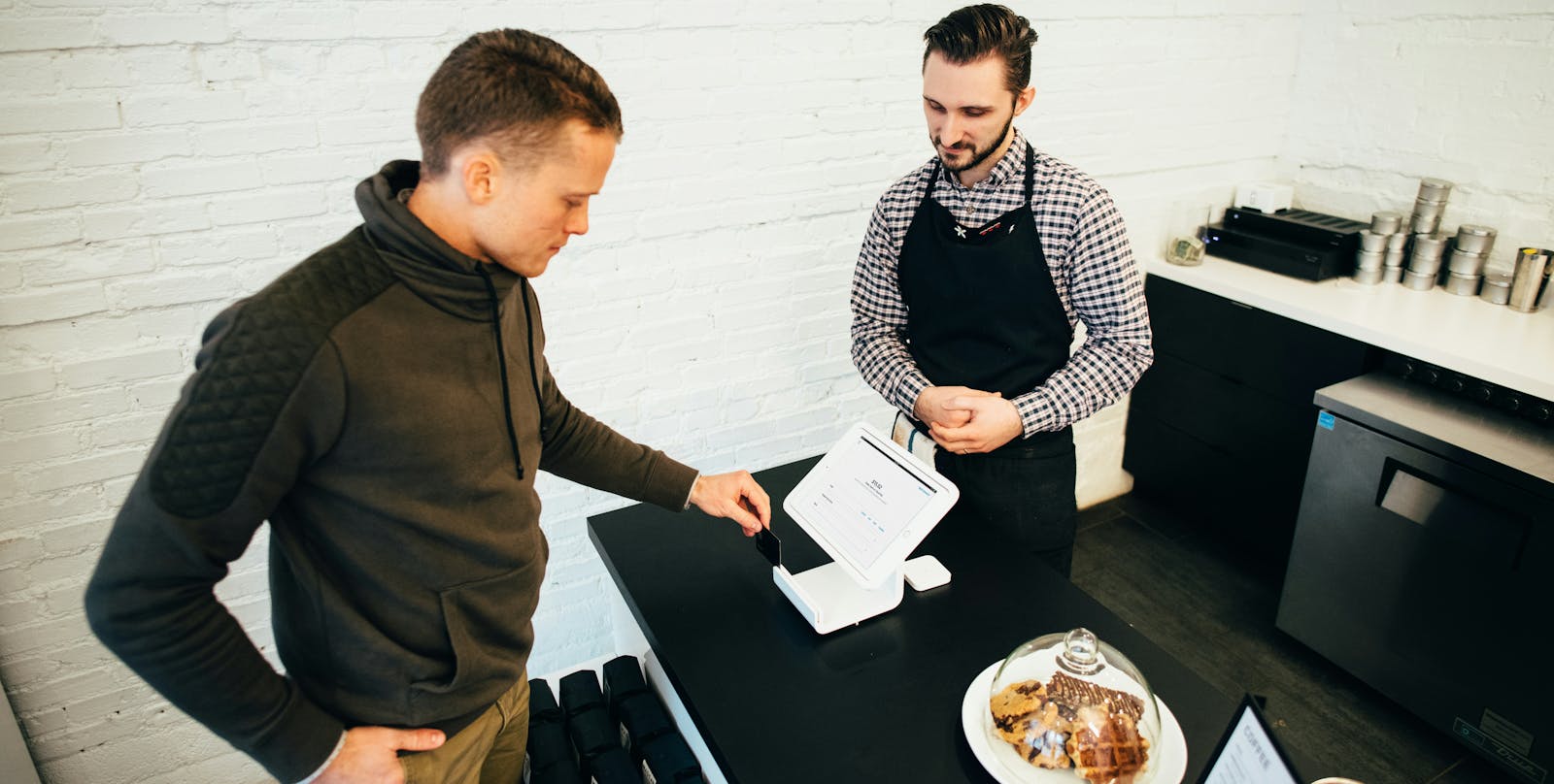 A customer using a restaurant POS system. 