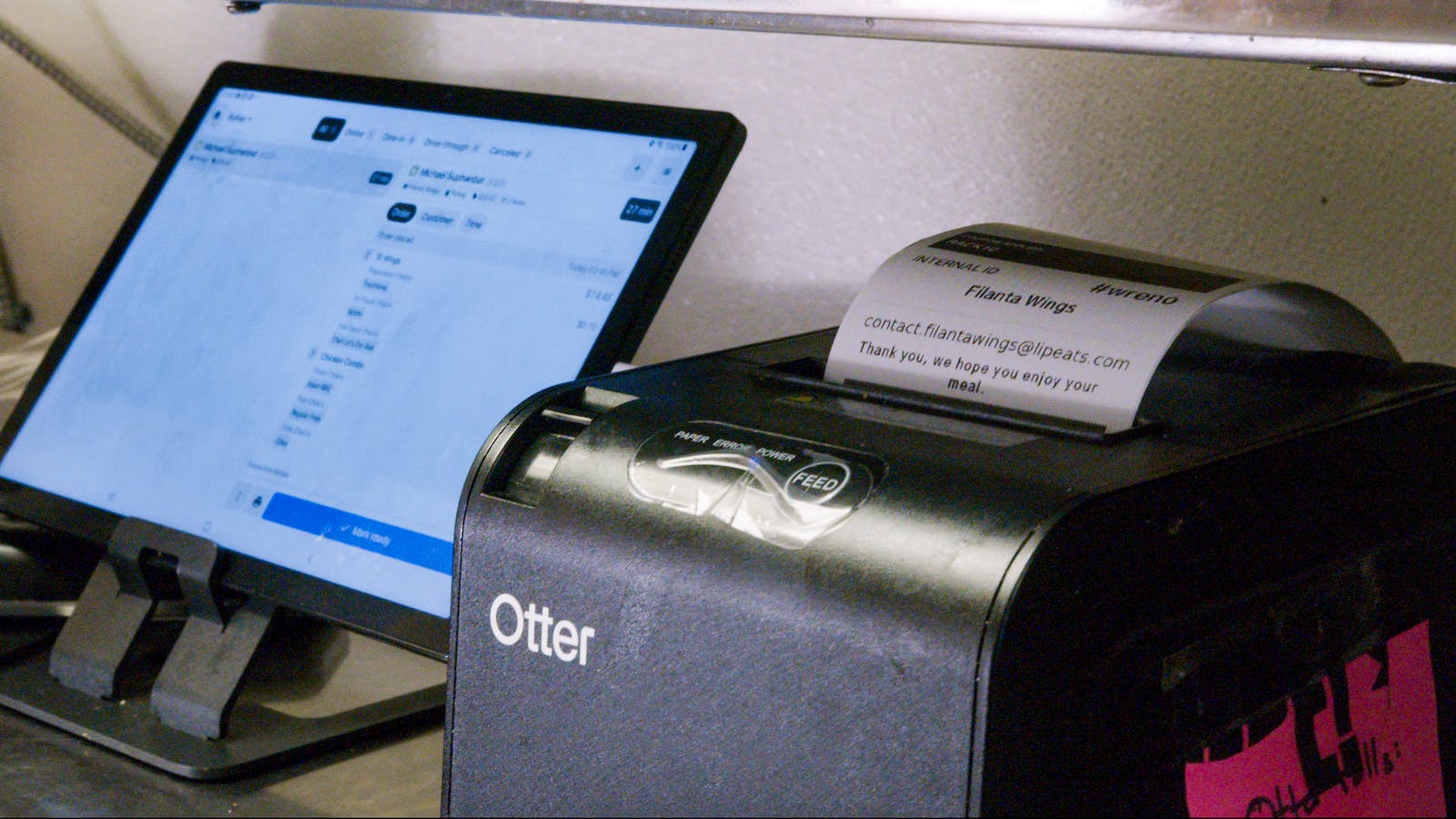 An Otter restaurant tablet and printer. 