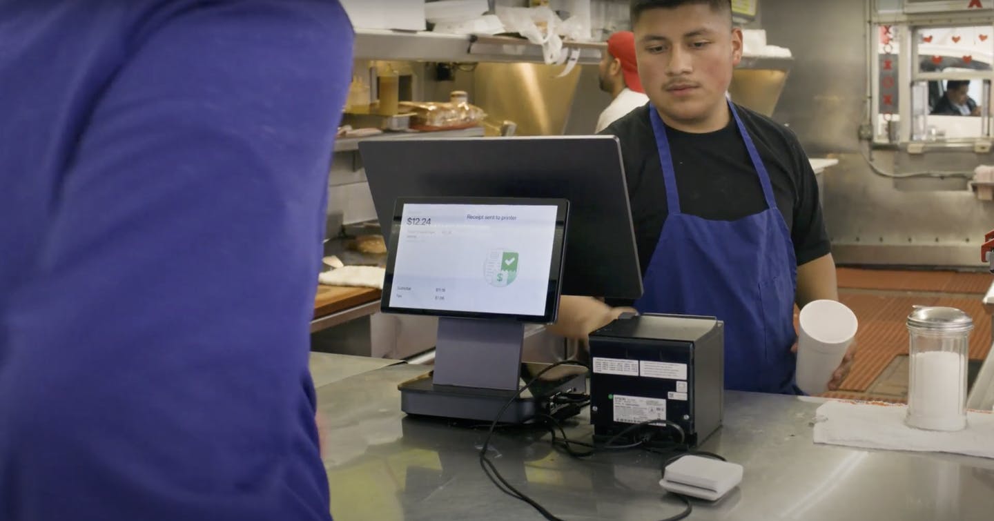 A restaurant staff member using Otter POS. 