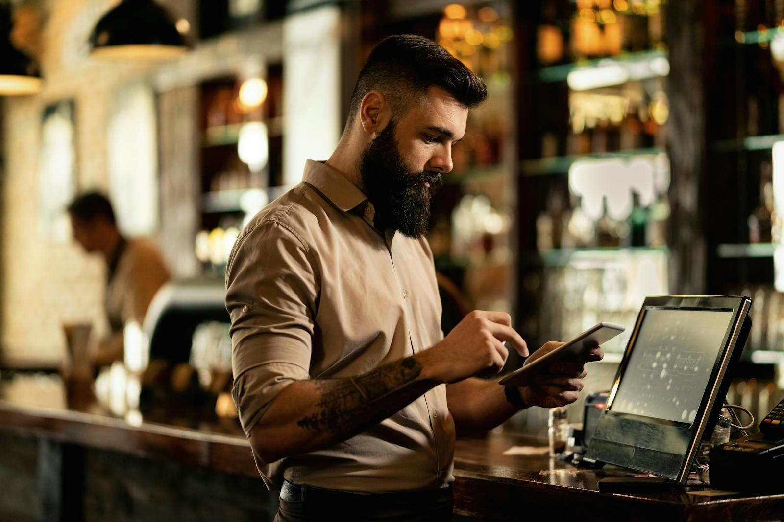 A staff member using a restaurant POS system. 