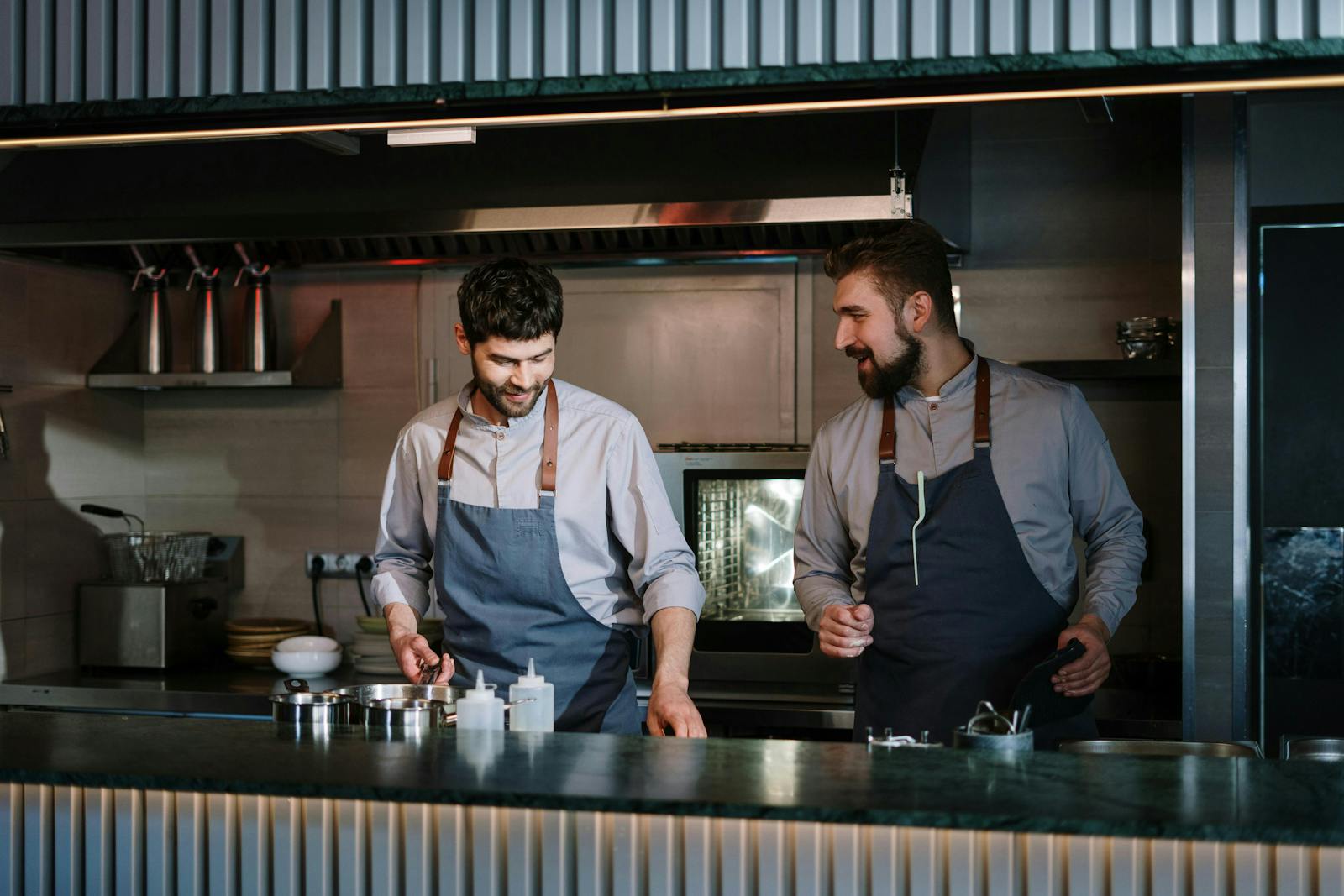 Some restaurant owners cooking a dish. 