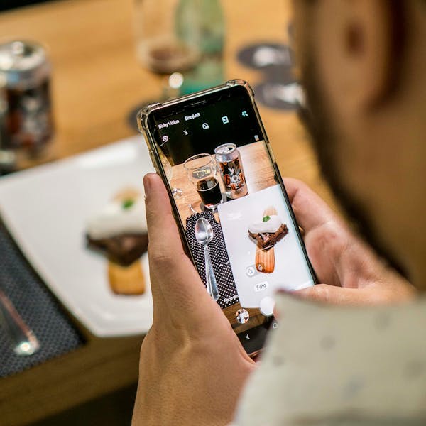 A restaurant owner making an Instagram Reel. 