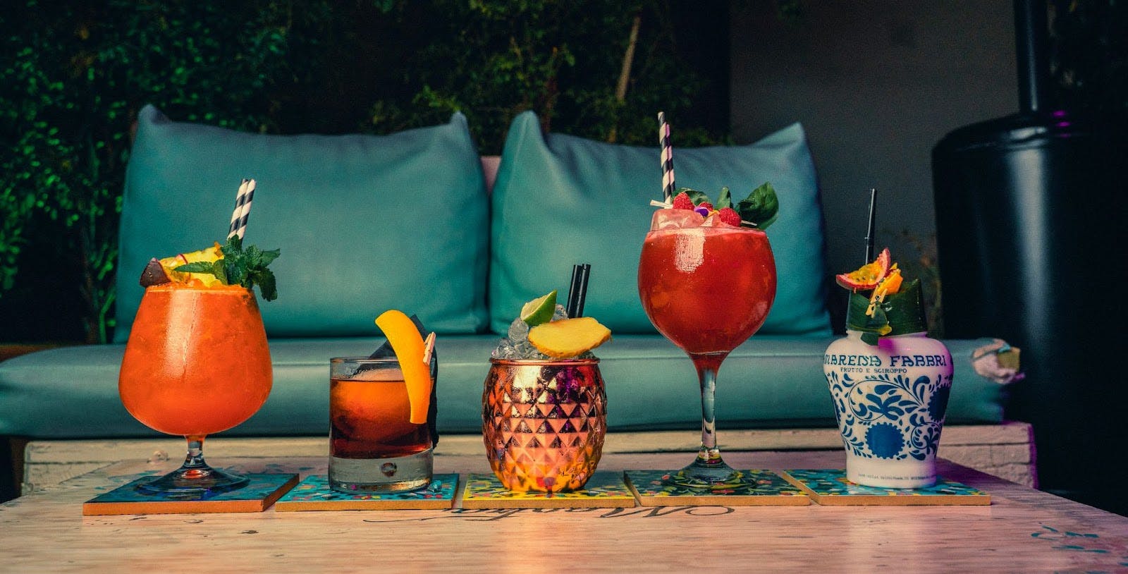 Image of different types of cocktails lined up on a table