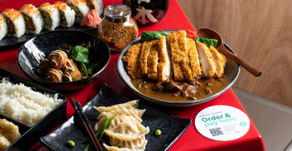 Image of Japanese food on the table, with a QR code sticker for ordering